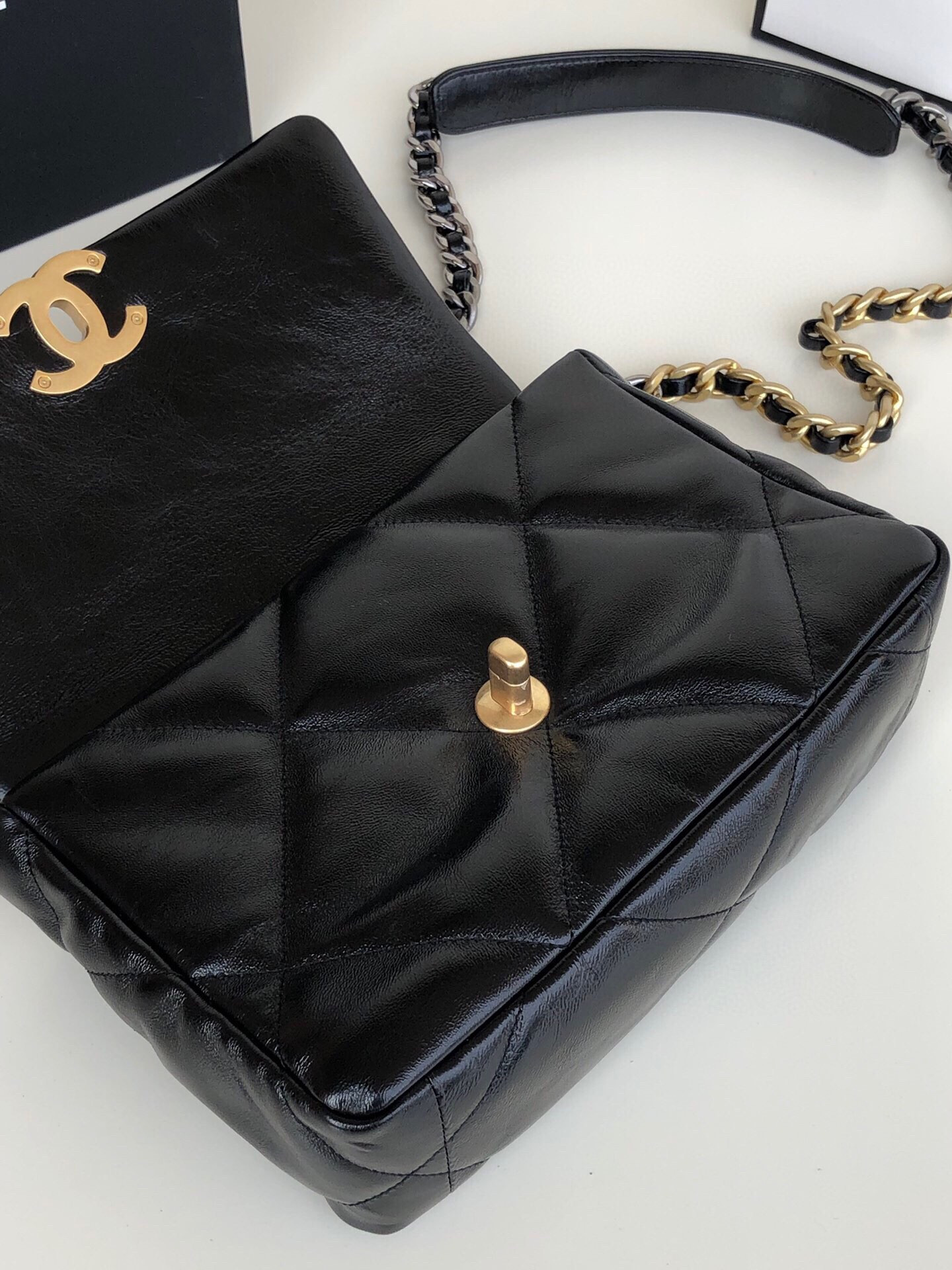 Ch*el 19 handbag shiny leather, gold-tone, silver-tone & ruthenium-finish metal black 6.2 × 10.1 × 3.5 in